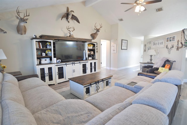 living room featuring ceiling fan, light hardwood / wood-style flooring, and vaulted ceiling with beams