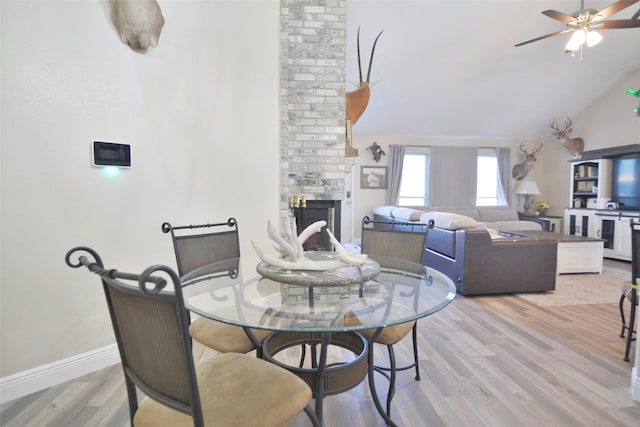 dining area featuring ceiling fan, lofted ceiling, and light hardwood / wood-style floors