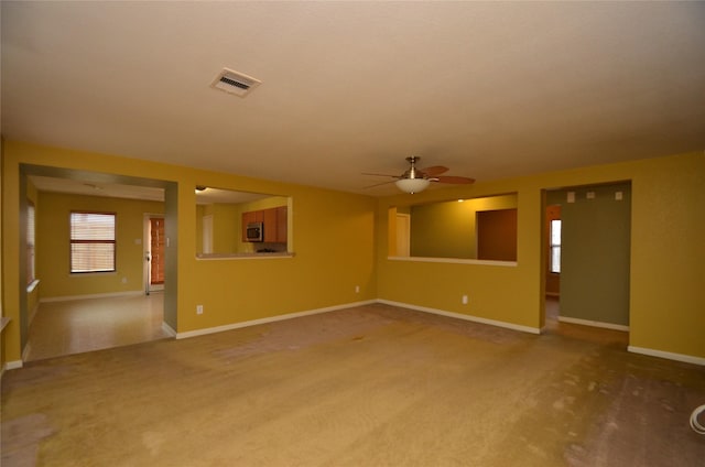 unfurnished living room with ceiling fan and carpet flooring