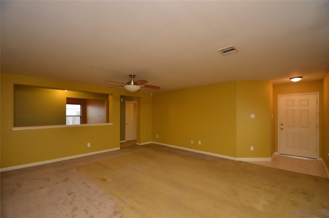 spare room featuring ceiling fan and carpet