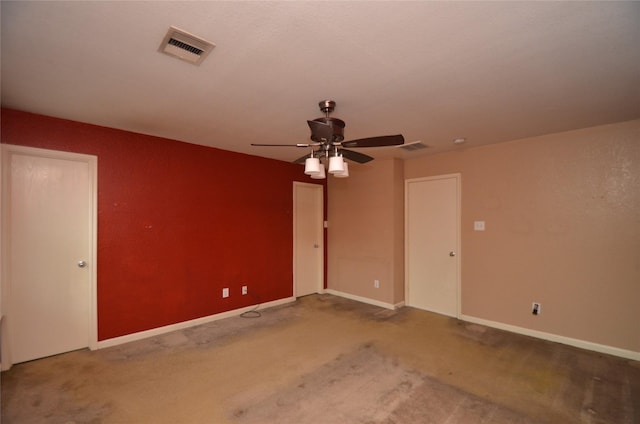 unfurnished room featuring ceiling fan and carpet