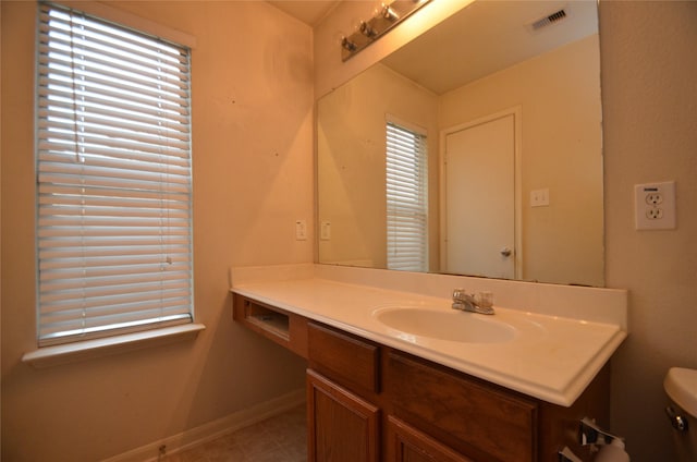 bathroom with vanity and toilet