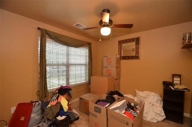 interior space with ceiling fan and carpet