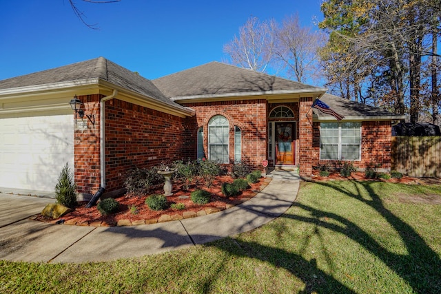 view of front of home with a garage and a front yard