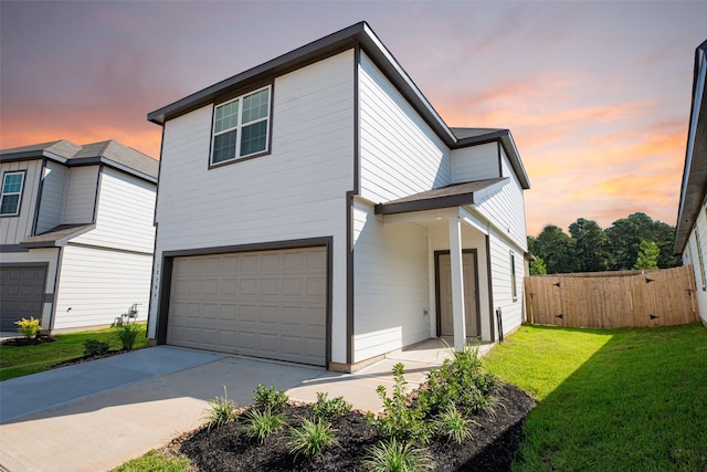 view of front facade featuring a garage and a lawn