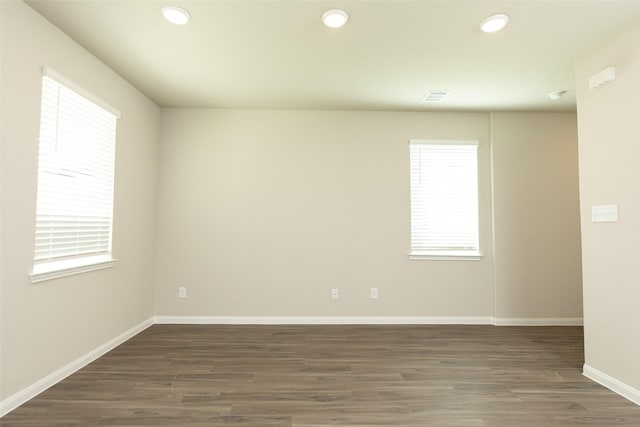 unfurnished room with dark hardwood / wood-style floors