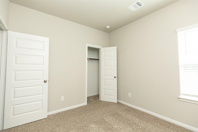 unfurnished bedroom with a closet and carpet