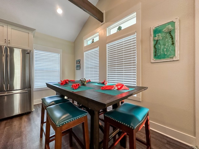 dining area with lofted ceiling with beams and dark hardwood / wood-style floors