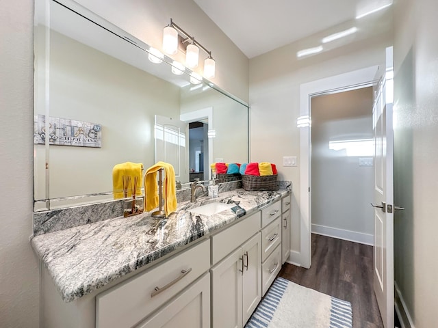 bathroom featuring hardwood / wood-style flooring and vanity