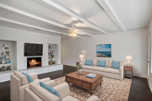 tiled living room with beamed ceiling, ceiling fan, built in features, and a fireplace