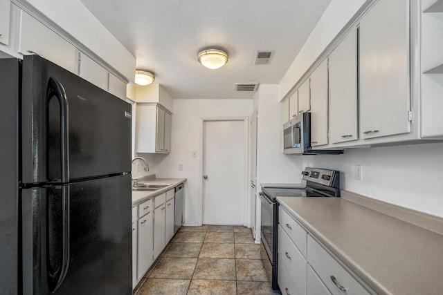 kitchen featuring stainless steel appliances, sink, and white cabinets