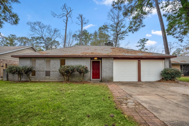 single story home with a garage, concrete driveway, a chimney, a front yard, and brick siding