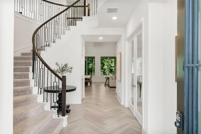 entrance foyer featuring french doors and light parquet floors