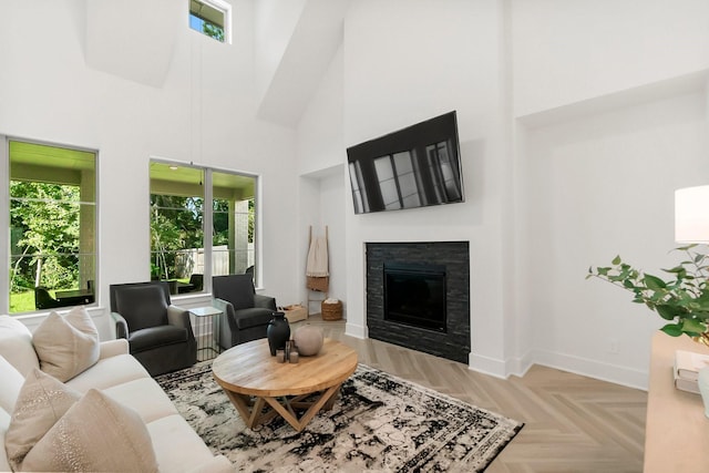 living room with light parquet flooring and a towering ceiling