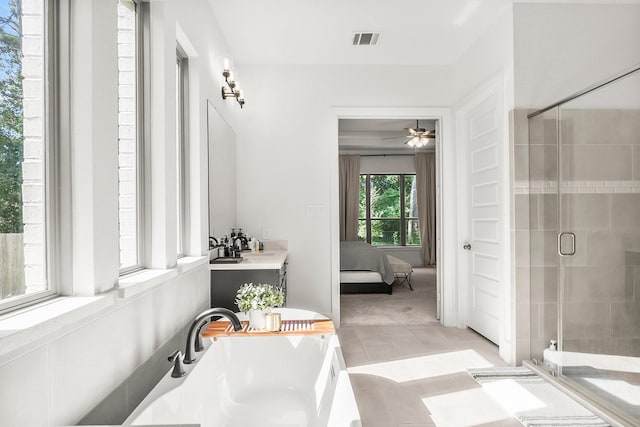 bathroom featuring tile patterned flooring and shower with separate bathtub