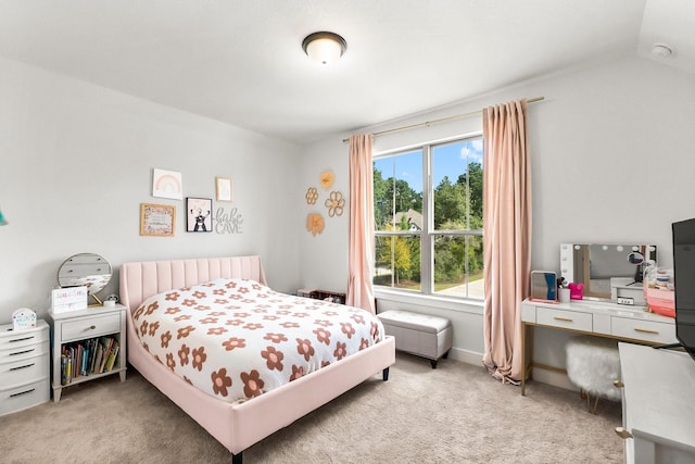 carpeted bedroom with lofted ceiling