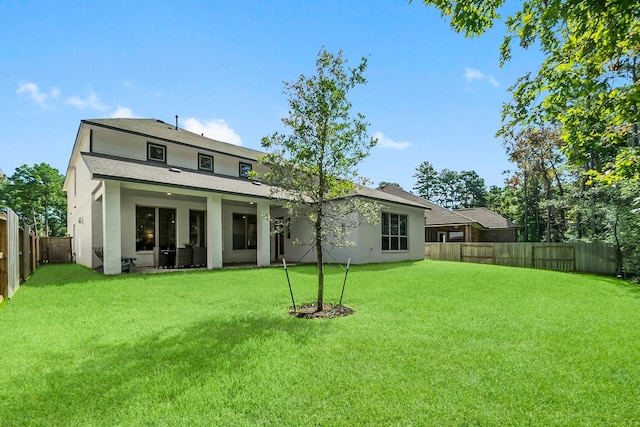 back of property featuring a lawn