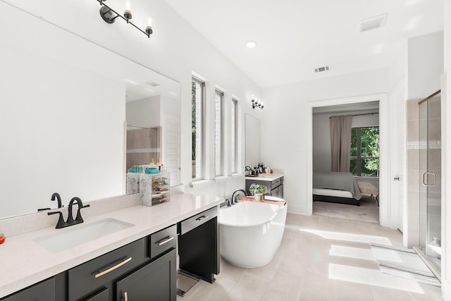 bathroom with independent shower and bath, vanity, plenty of natural light, and tile patterned flooring