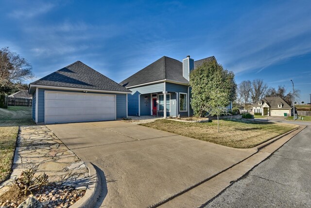2106 Springwood, Brenham, TX 77833 - view of front of property with concrete driveway, a front lawn, a chimney, roof with shingles, and covered porch