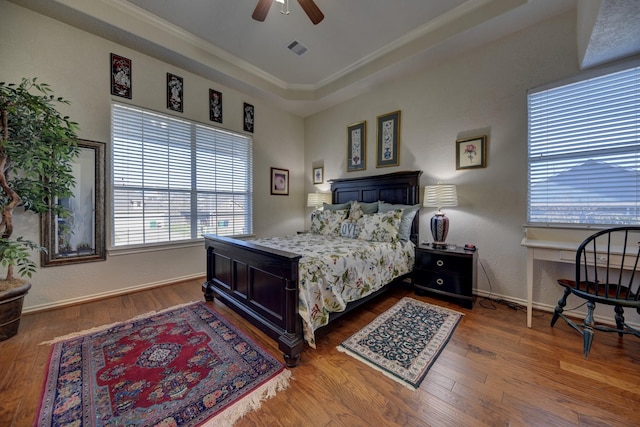 2106 Springwood, Brenham, TX 77833 - bedroom featuring a tray ceiling, wood finished floors, baseboards, ceiling fan, and crown molding