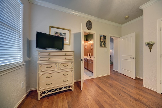 2106 Springwood, Brenham, TX 77833 - bedroom with crown molding, wood finished floors, baseboards, and connected bathroom