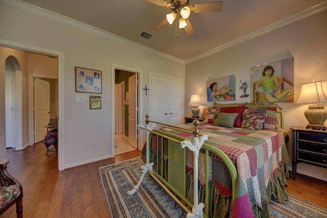 2106 Springwood, Brenham, TX 77833 - bedroom featuring ornamental molding, wood finished floors, ceiling fan, baseboards, and arched walkways