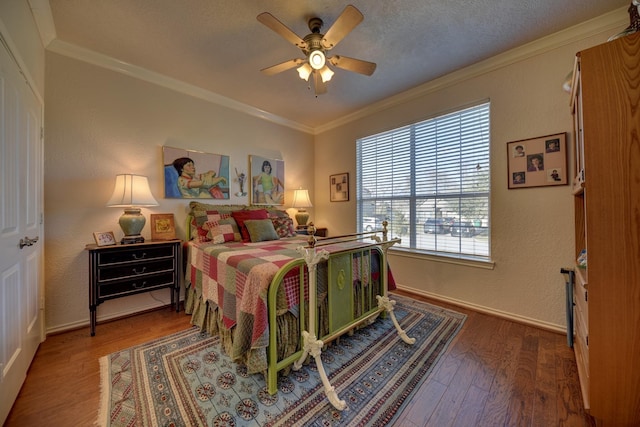 2106 Springwood, Brenham, TX 77833 - bedroom featuring crown molding, wood finished floors, baseboards, and ceiling fan