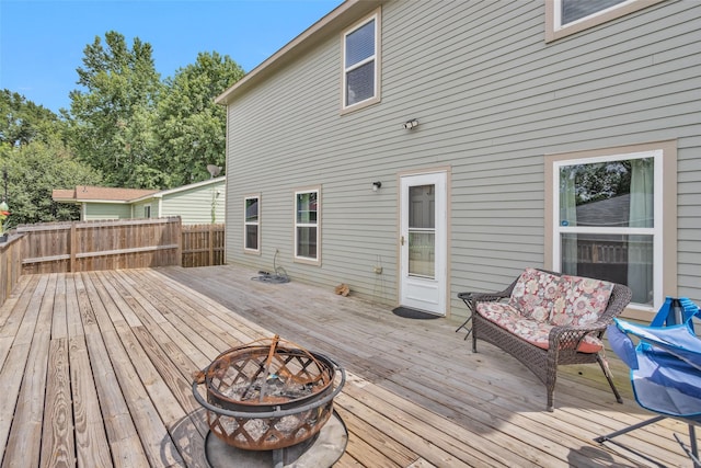 wooden deck featuring an outdoor fire pit