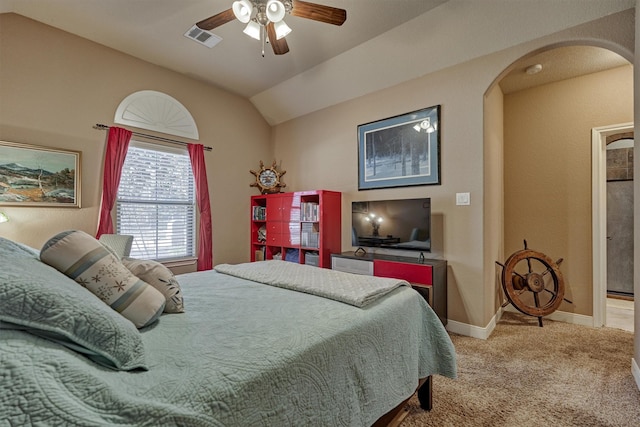 bedroom with ceiling fan, lofted ceiling, and light colored carpet