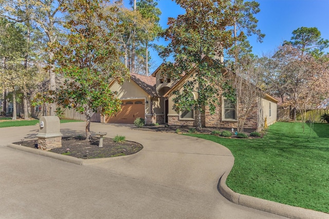 view of front of house featuring a garage and a front lawn