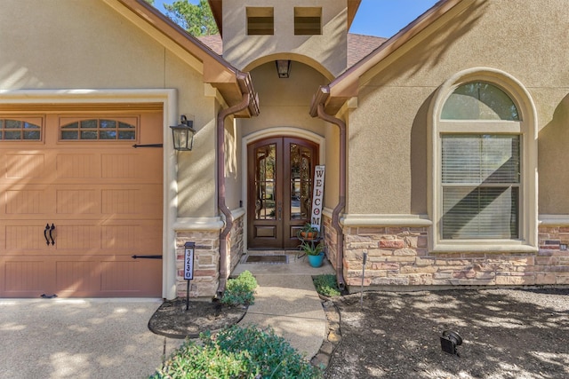 entrance to property featuring french doors and a garage