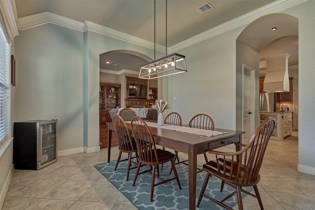 tiled dining room featuring wine cooler and ornamental molding