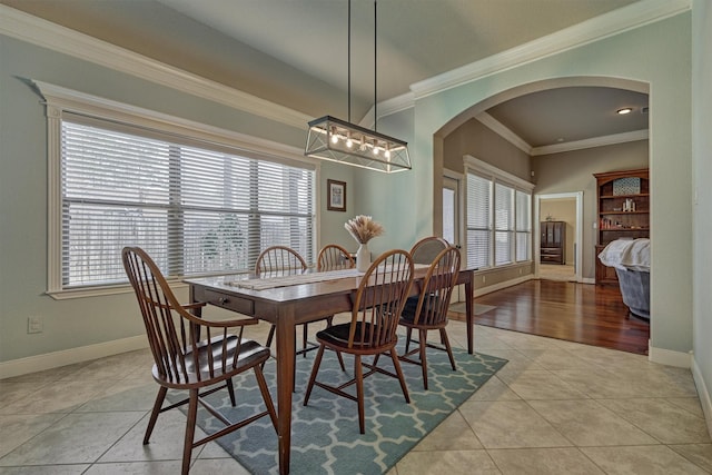 dining room featuring plenty of natural light, ornamental molding, and light tile patterned flooring