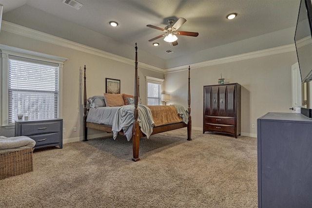 carpeted bedroom with a raised ceiling, crown molding, and ceiling fan