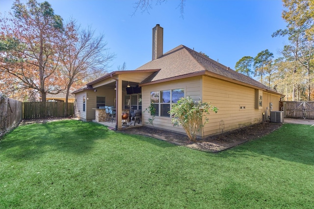 back of house featuring a yard, a patio, and central air condition unit