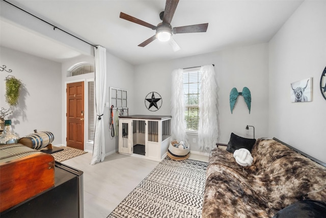 living area with ceiling fan and light wood-type flooring