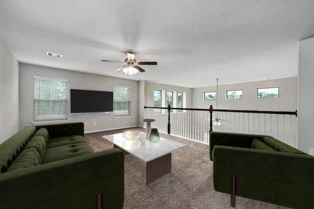 carpeted living room featuring ceiling fan and a wealth of natural light