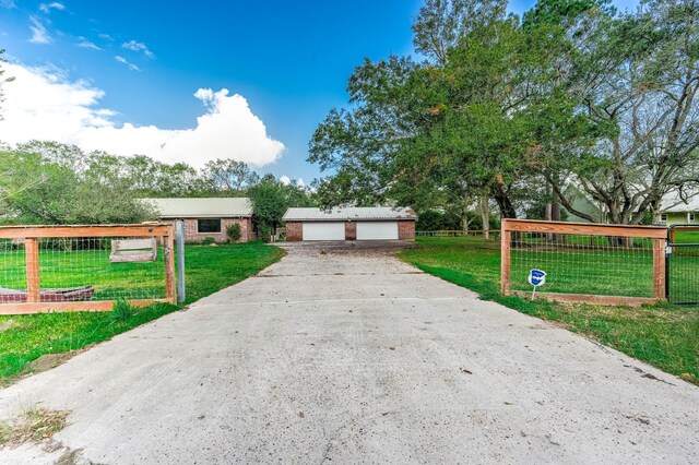 ranch-style house featuring a garage and a front yard