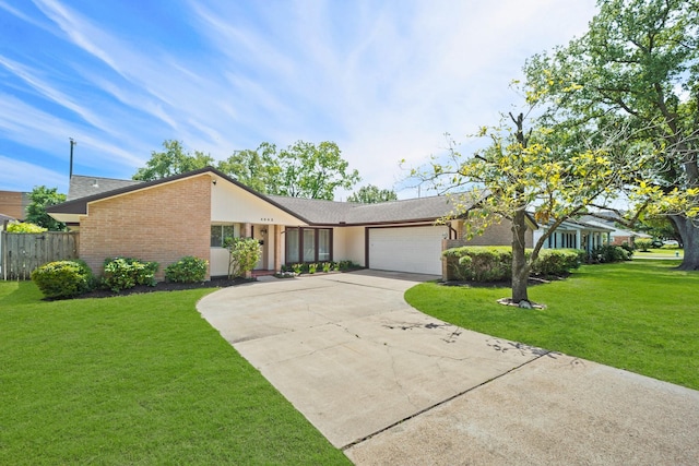 single story home with a garage and a front lawn