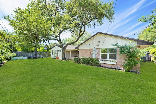 back of house with a lawn