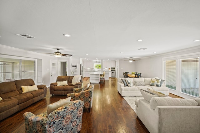 living room featuring crown molding, ceiling fan, and dark hardwood / wood-style floors