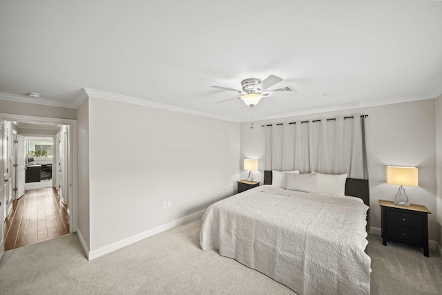 bedroom with ornamental molding, carpet, and ceiling fan