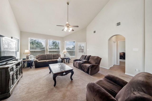 carpeted living room featuring ceiling fan and high vaulted ceiling