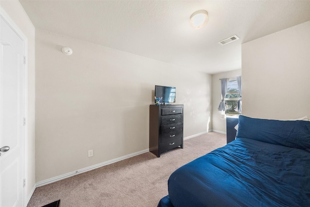 bedroom with light colored carpet