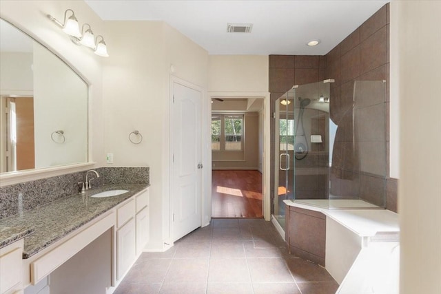 bathroom with tile patterned flooring, vanity, and a shower with shower door