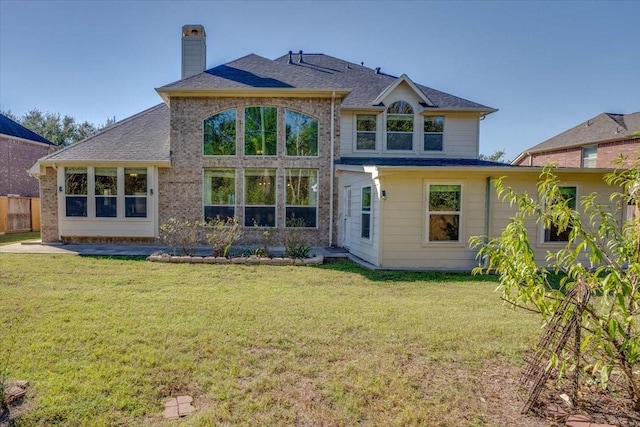 back of house featuring a lawn