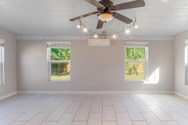 unfurnished room featuring ceiling fan, a wall unit AC, and a textured ceiling