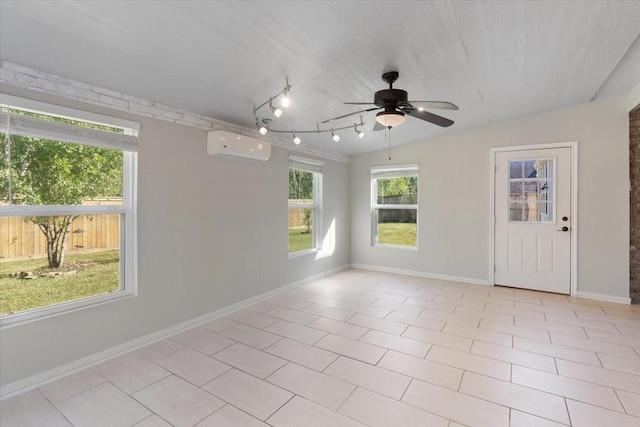 empty room with lofted ceiling, light tile patterned floors, ceiling fan, a wall mounted air conditioner, and a textured ceiling