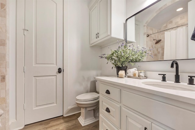 bathroom featuring vanity, hardwood / wood-style floors, a shower with curtain, and toilet