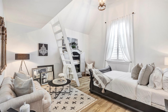 bedroom with lofted ceiling and light wood-type flooring